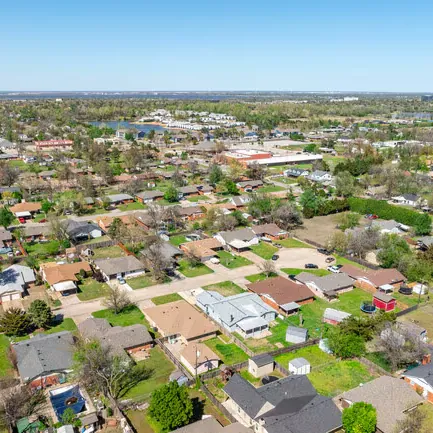 Aerial view of tree-lined residential streets and single-story homes in Warr Acres, Oklahoma.