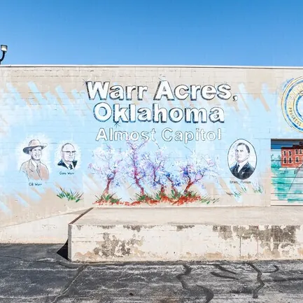 Warr Acres, Oklahoma "Almost Capital" mural painted on the side of a commercial building.
