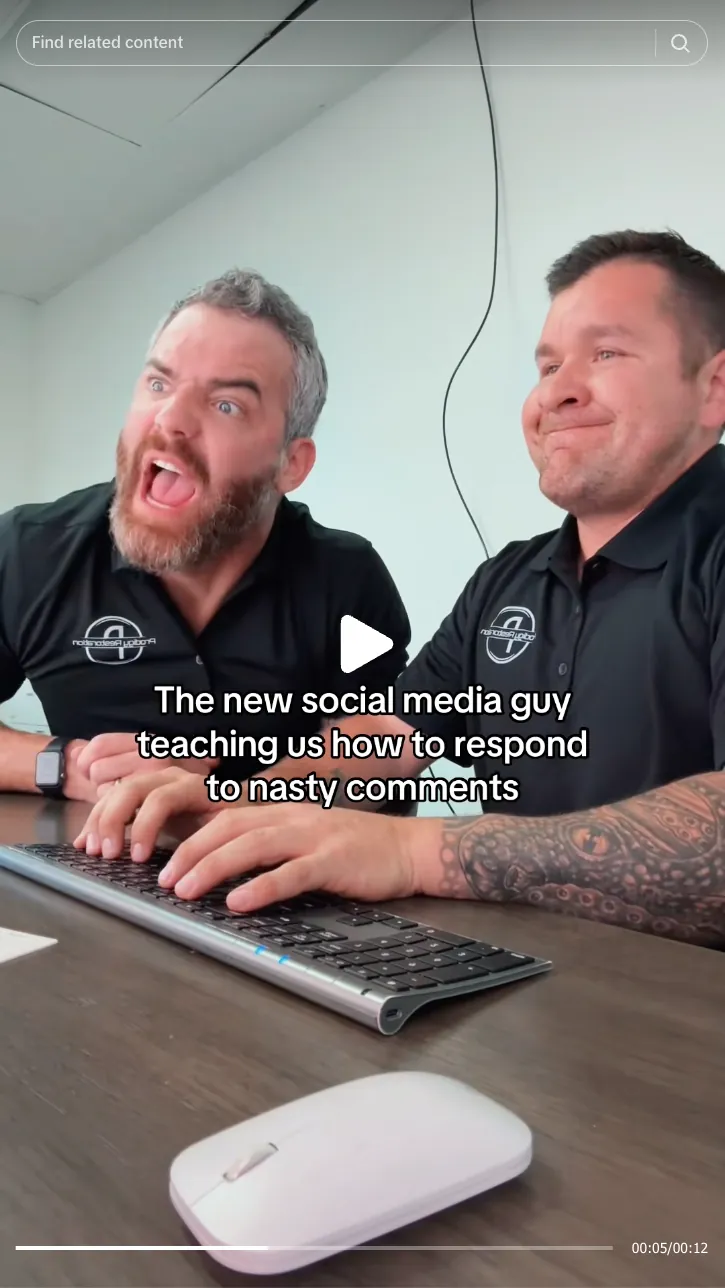Roofing by Prodigy - Two men in matching black polo shirts sit at a desk with a keyboard; one man looks emphatic while the other smiles, with text overlay about responding to nasty comments.