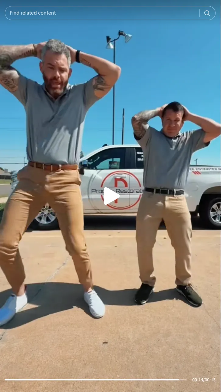 Roofing by Prodigy - Two men with tattoos wearing gray shirts and khaki pants stand on a concrete surface with hands on their heads in front of a truck under clear blue sky.